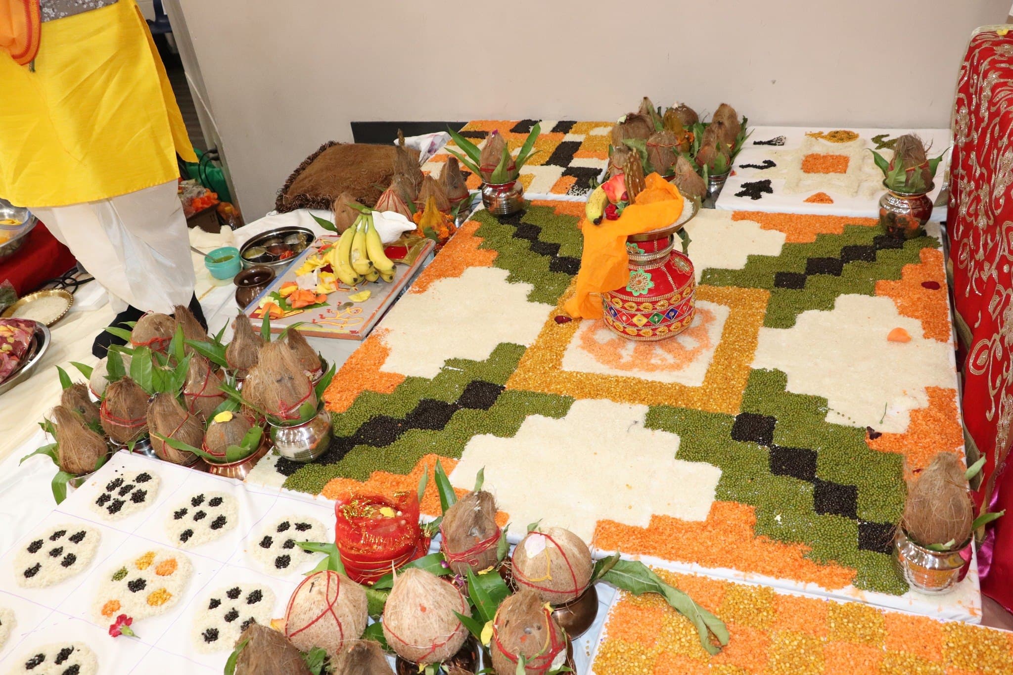 Grains, a kalash, and samagri arranged in a colourful havan mandala