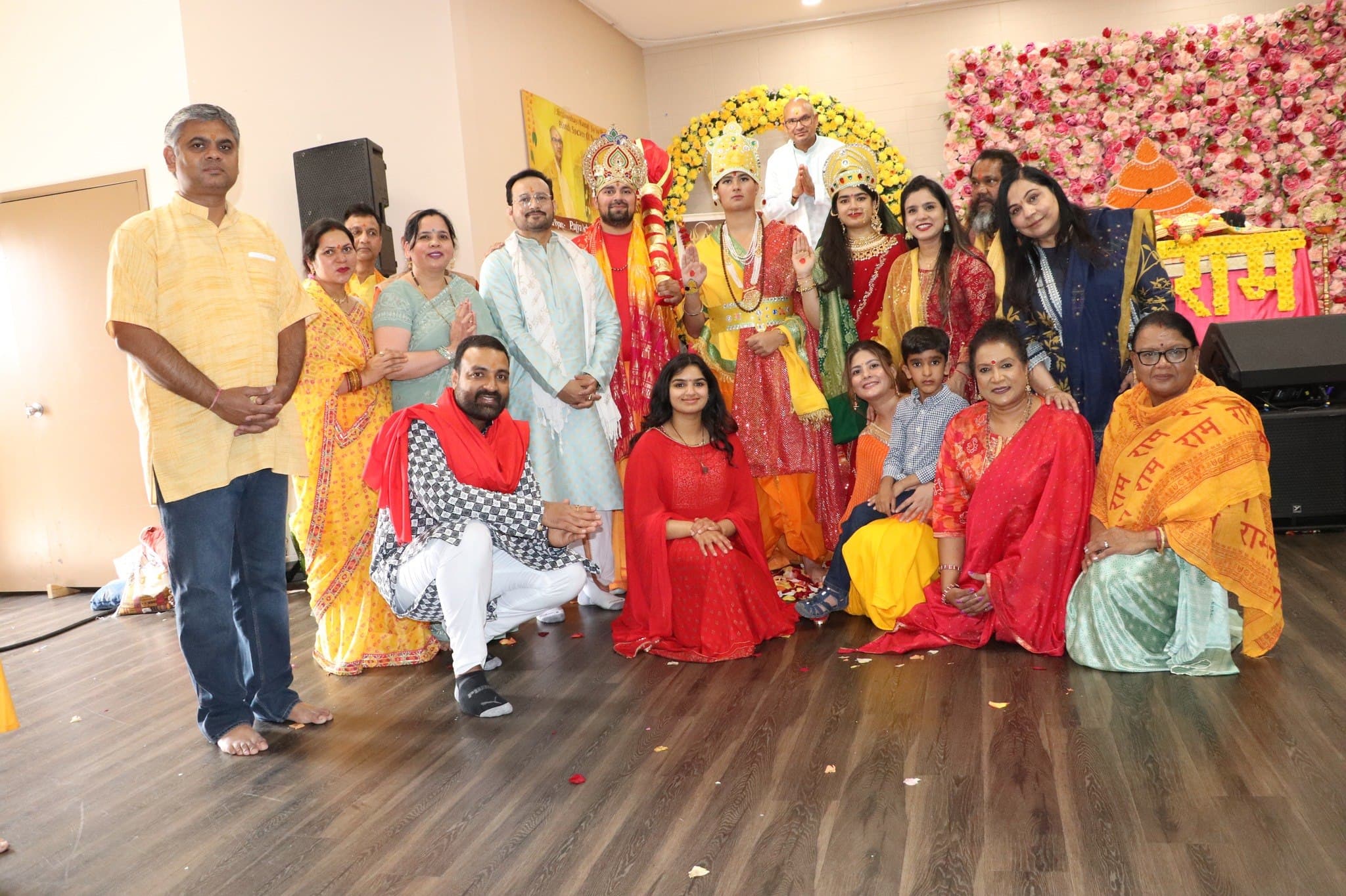 Volunteers gathered around the Ram Darbar tableau beneath a Shri Ram backdrop