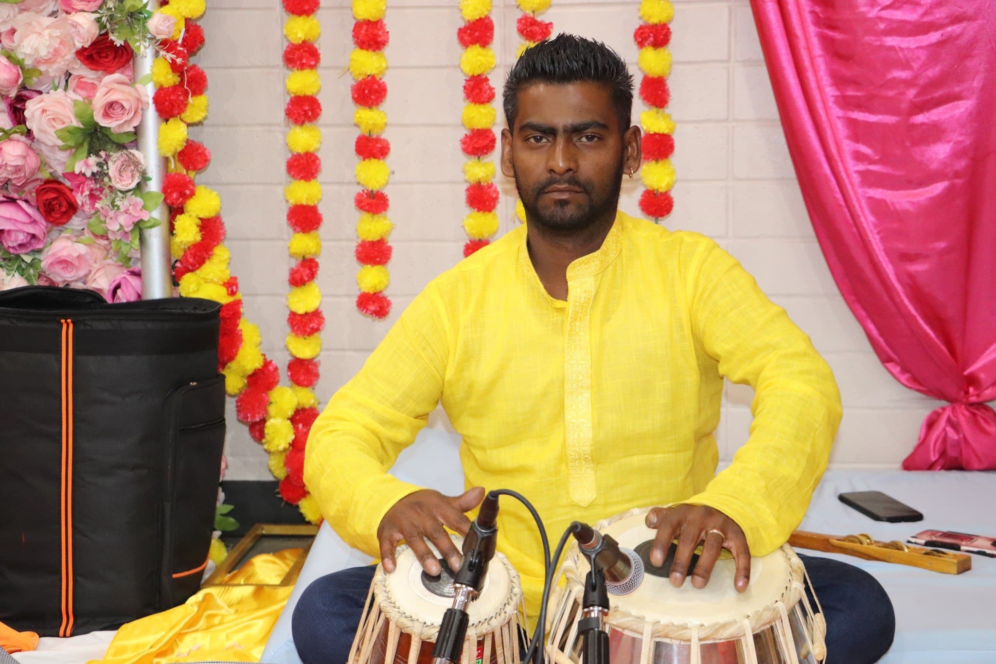 A musician plays the tabla during the bhajans