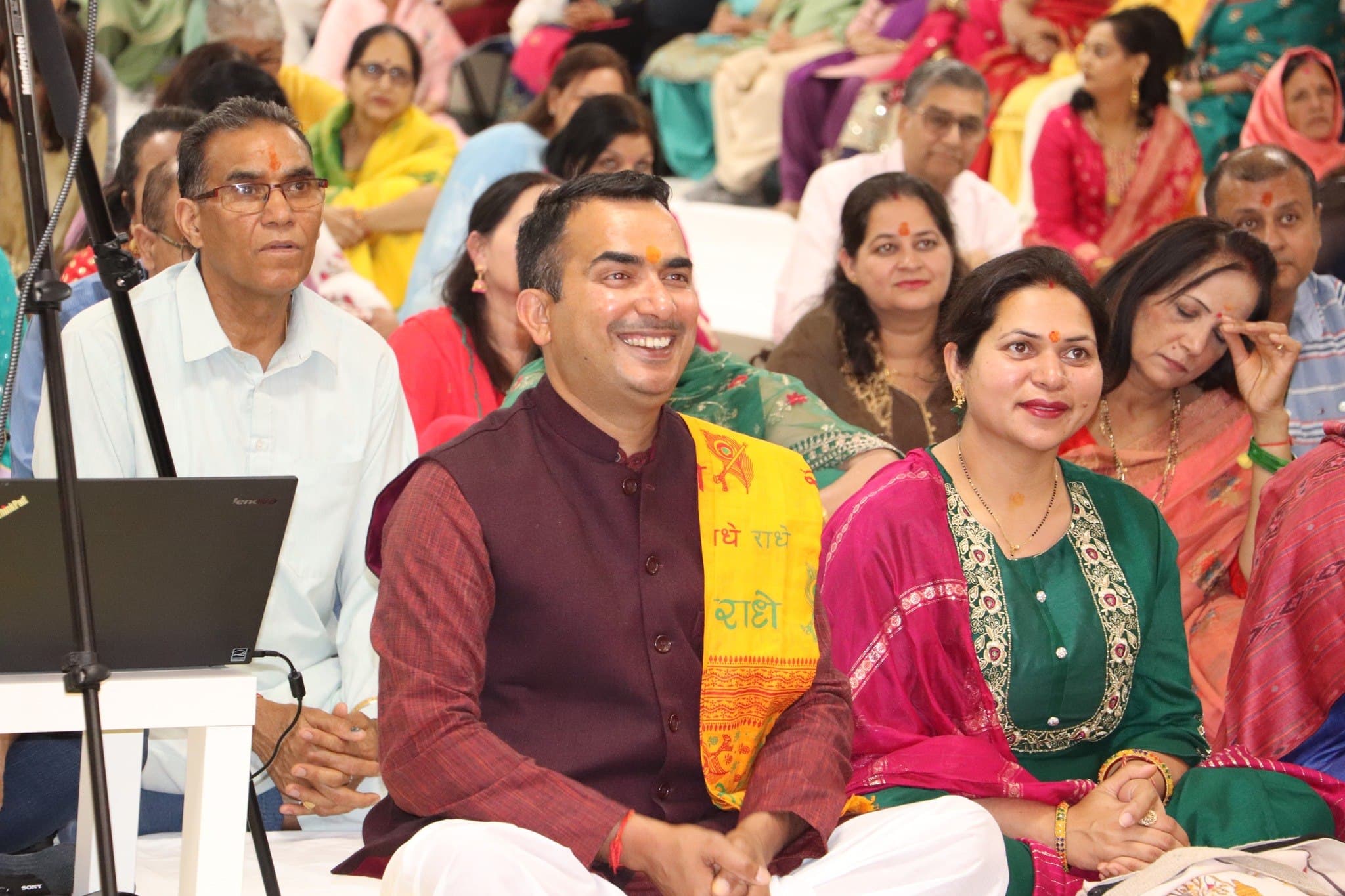 A couple seated among the congregation during the Ram Katha