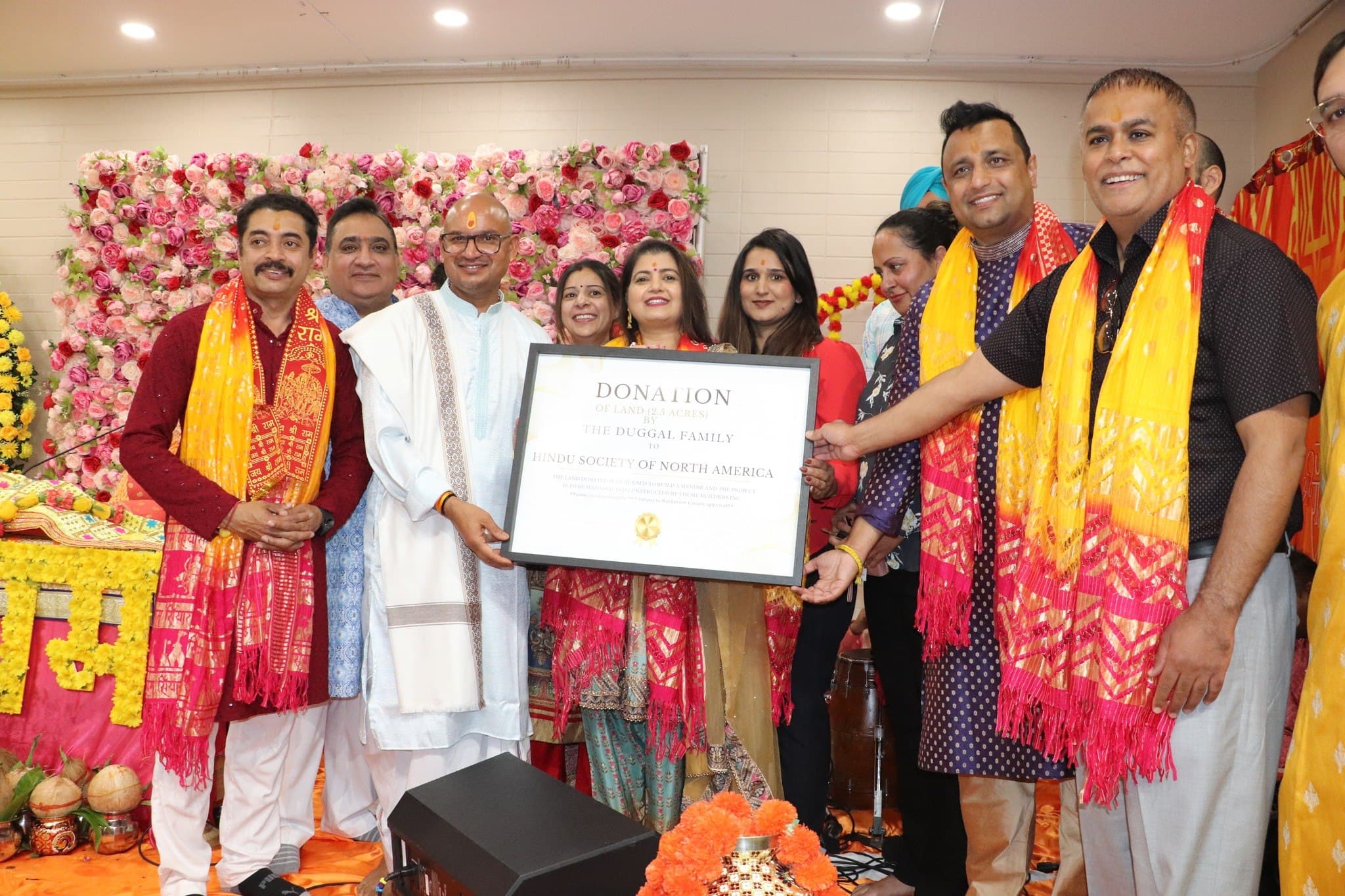 Organisers present a donation honour to a contributing family