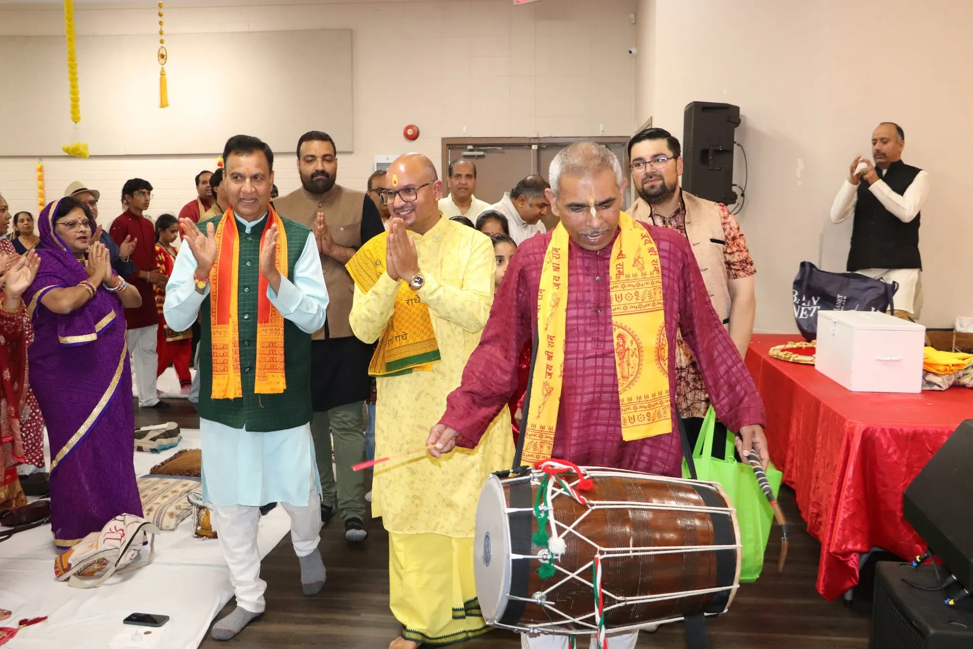 The community welcomes Acharya ji with dholak and garlands