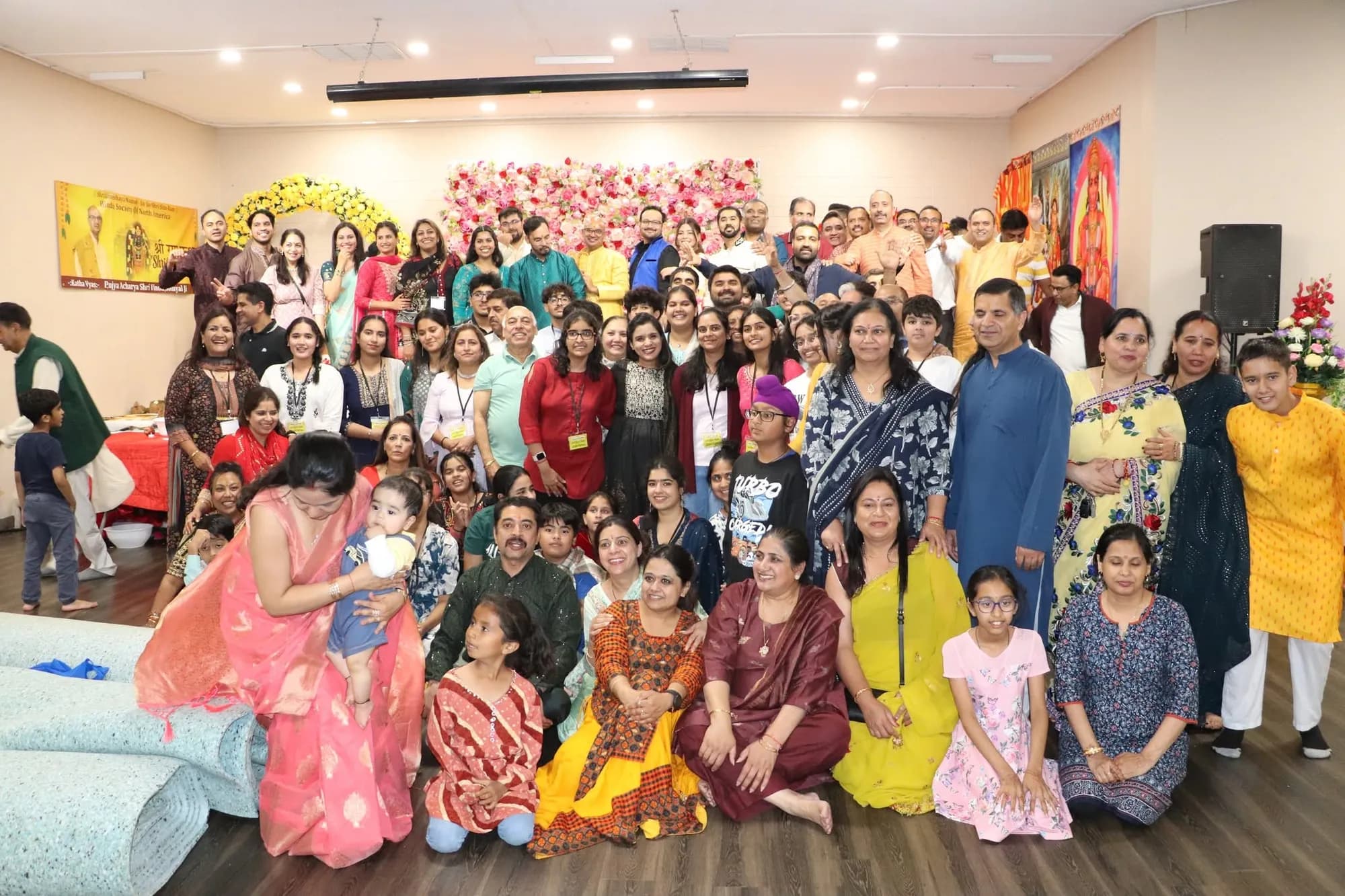 A large group photo of families gathered for the Shri Ram Katha