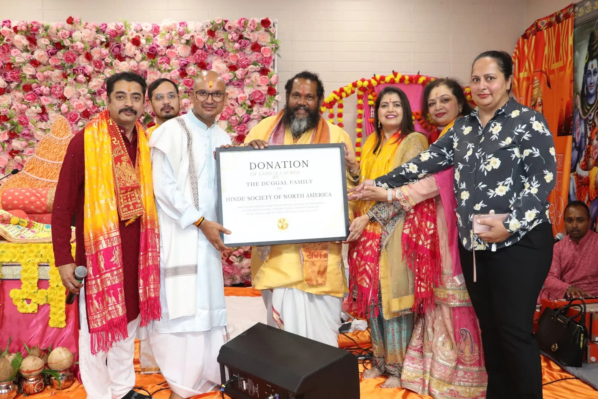 Organisers present a donation honour to a contributing family on stage