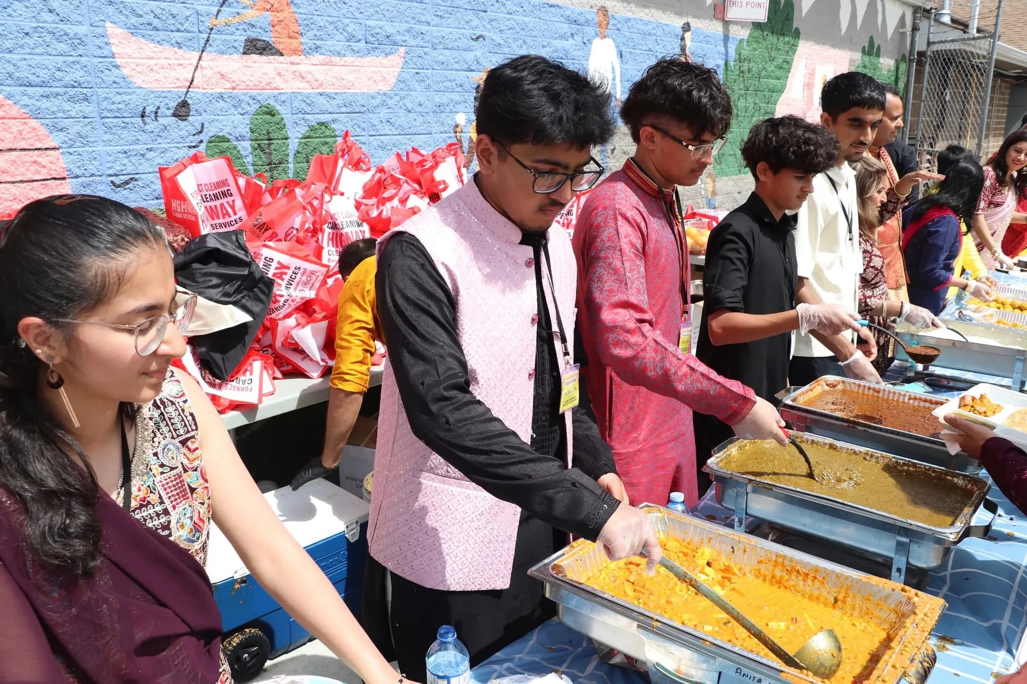 Volunteers serving the community meal during the katha