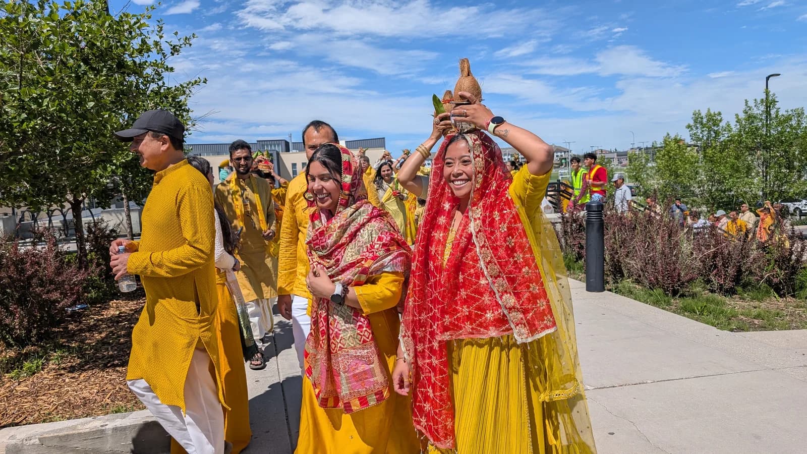 A devotee carries a sacred kalash on her head during the opening kalash yatra