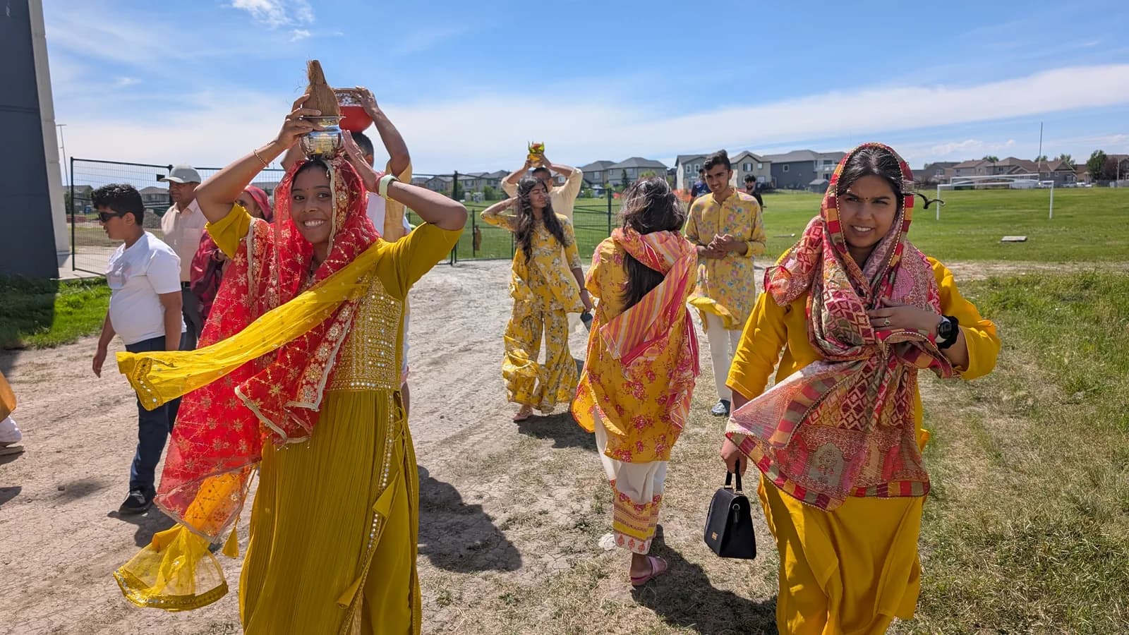 Women in saffron process with kalash during the kalash yatra
