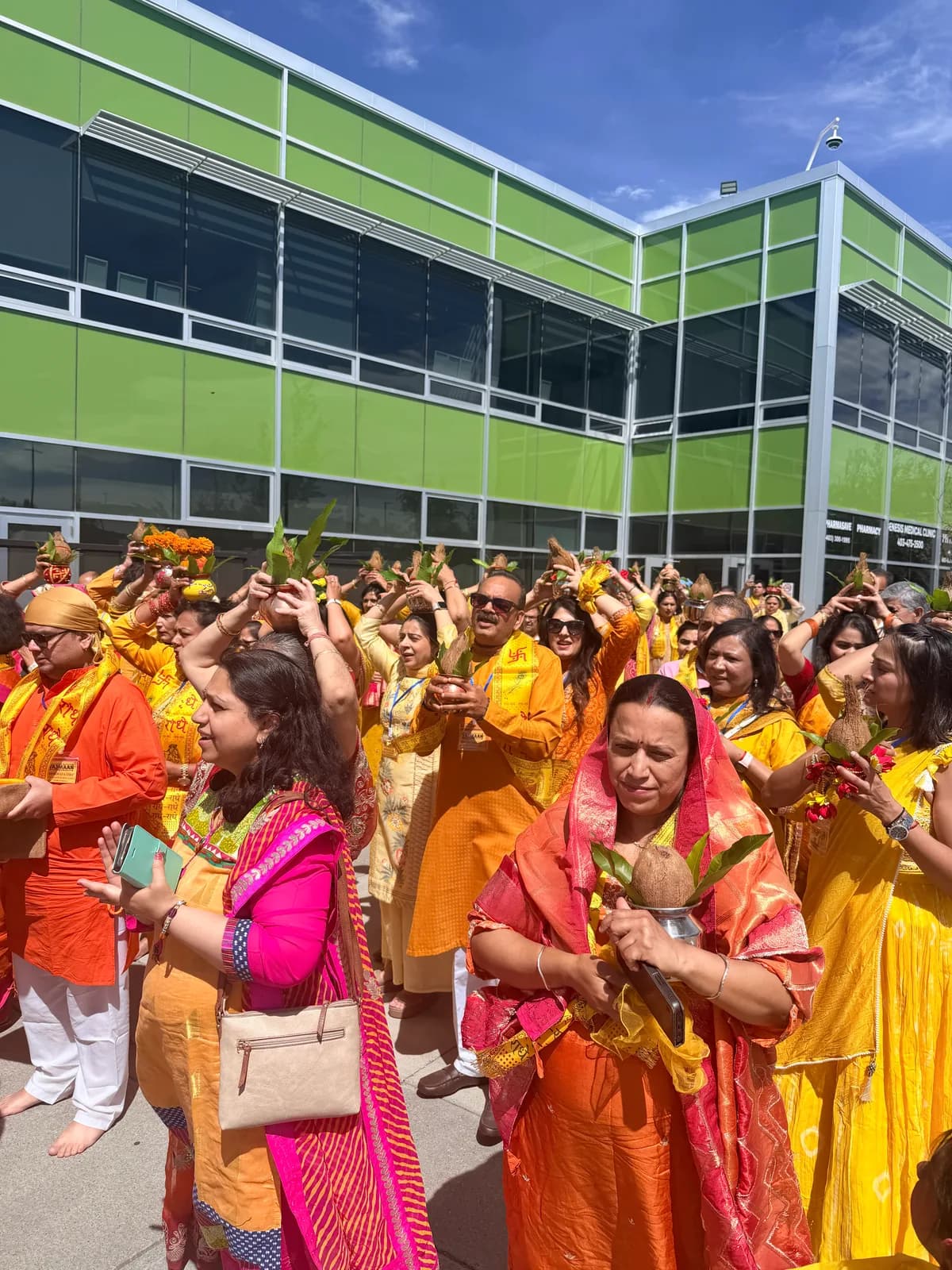 Devotees raise kalash and coconuts in celebration during the procession