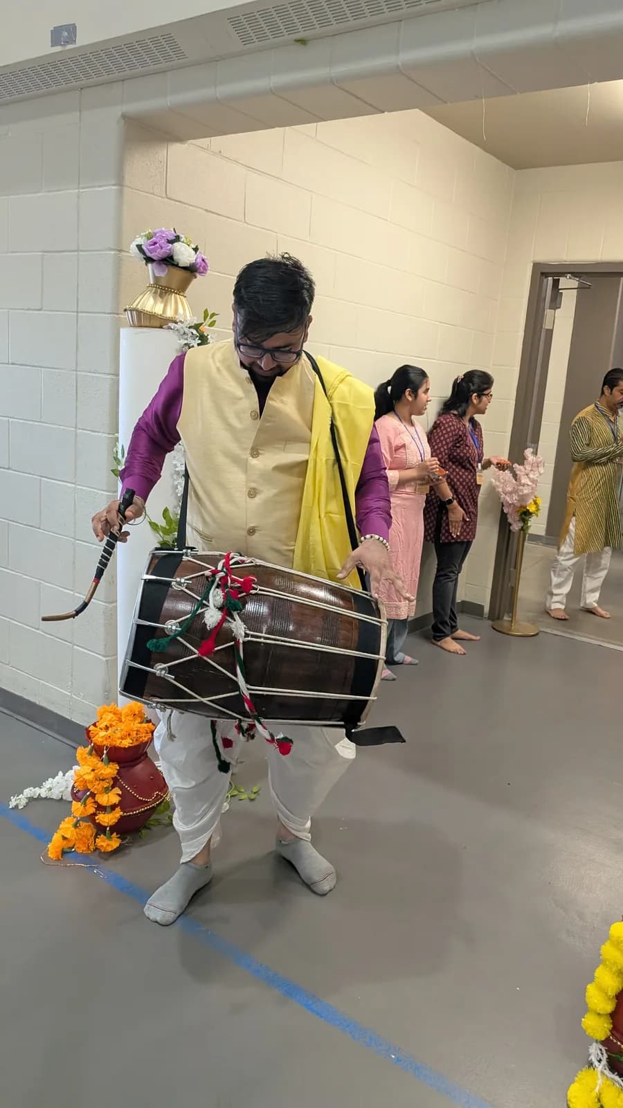 A dhol player fills the hall with rhythm as the evening begins