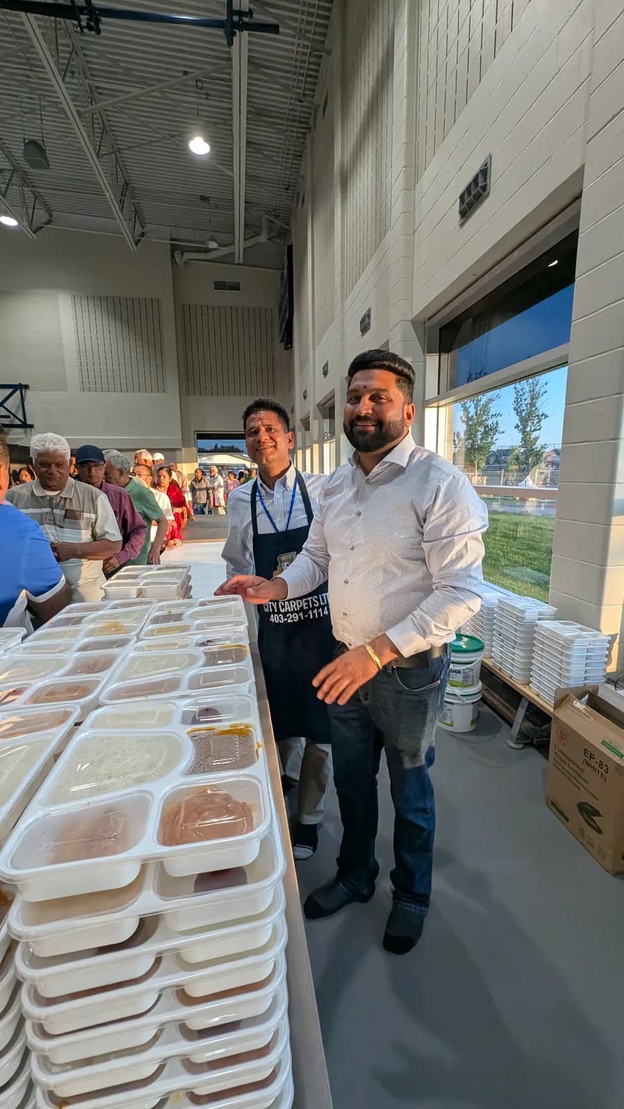 Volunteers serve prasad to the community