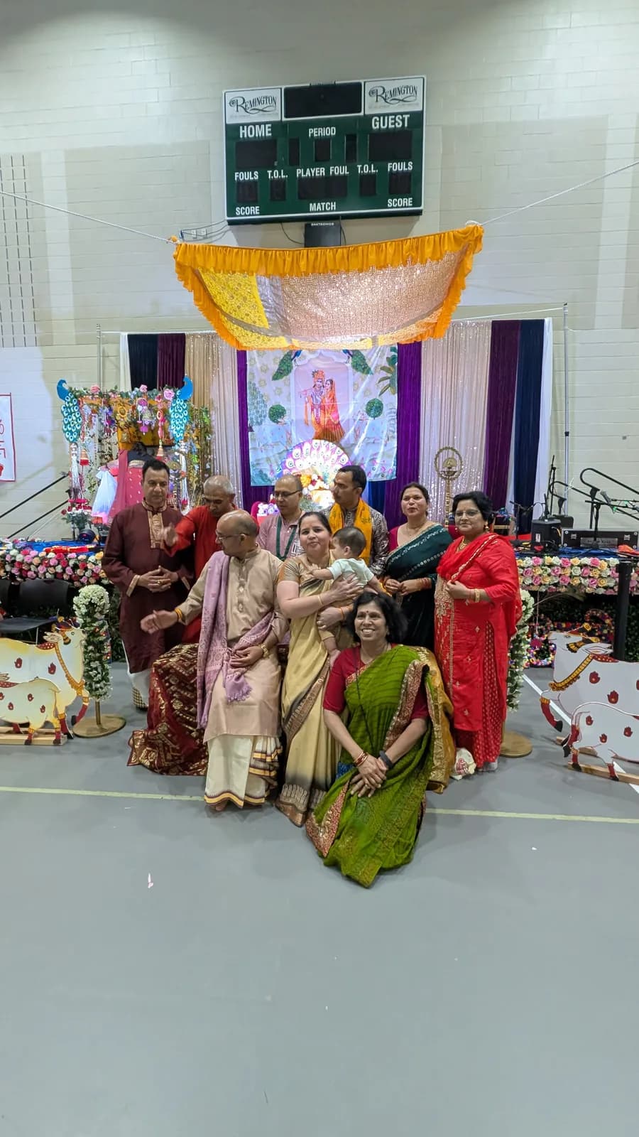 Families gather before the stage for a group photo