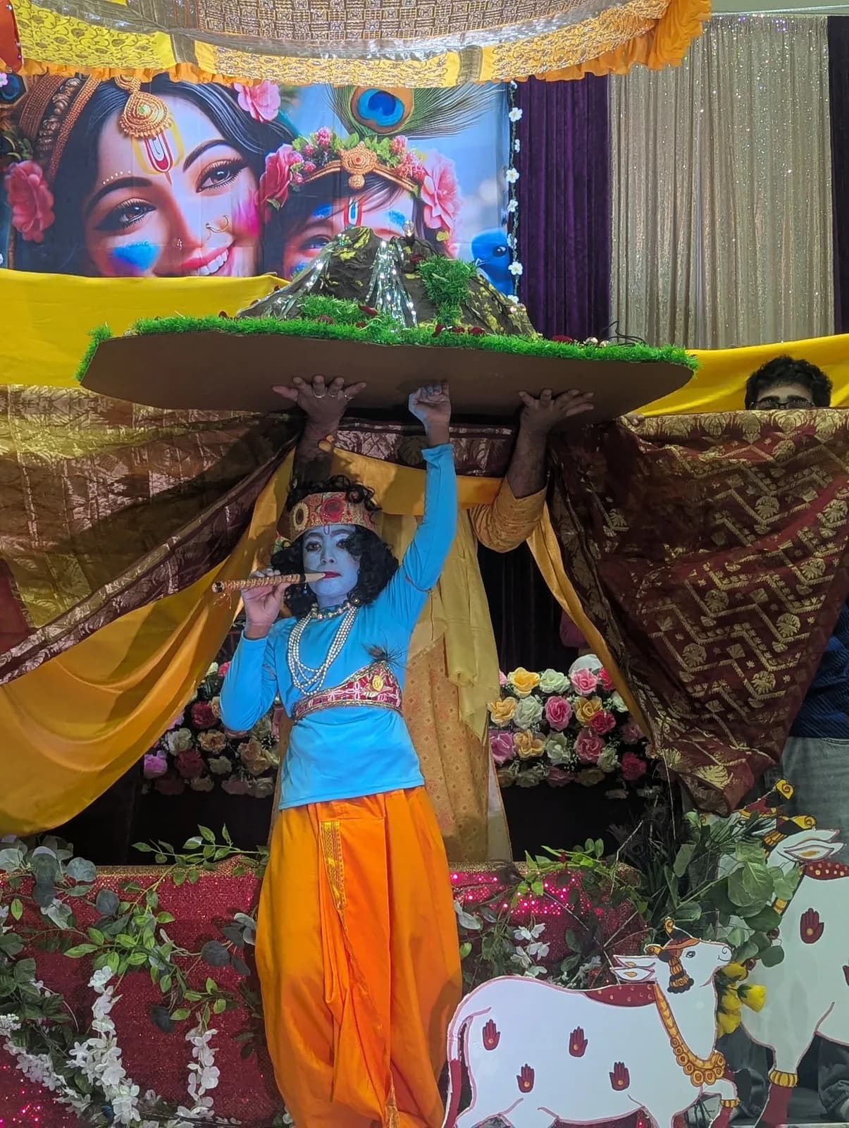 A child as Krishna lifts the Govardhan hill during the Govardhan Leela