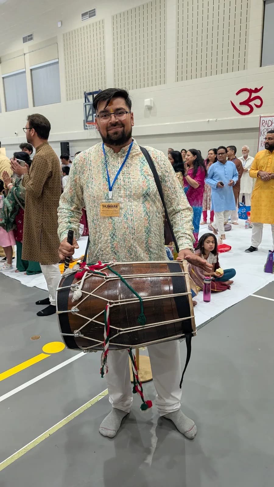 A dhol player leads the celebration